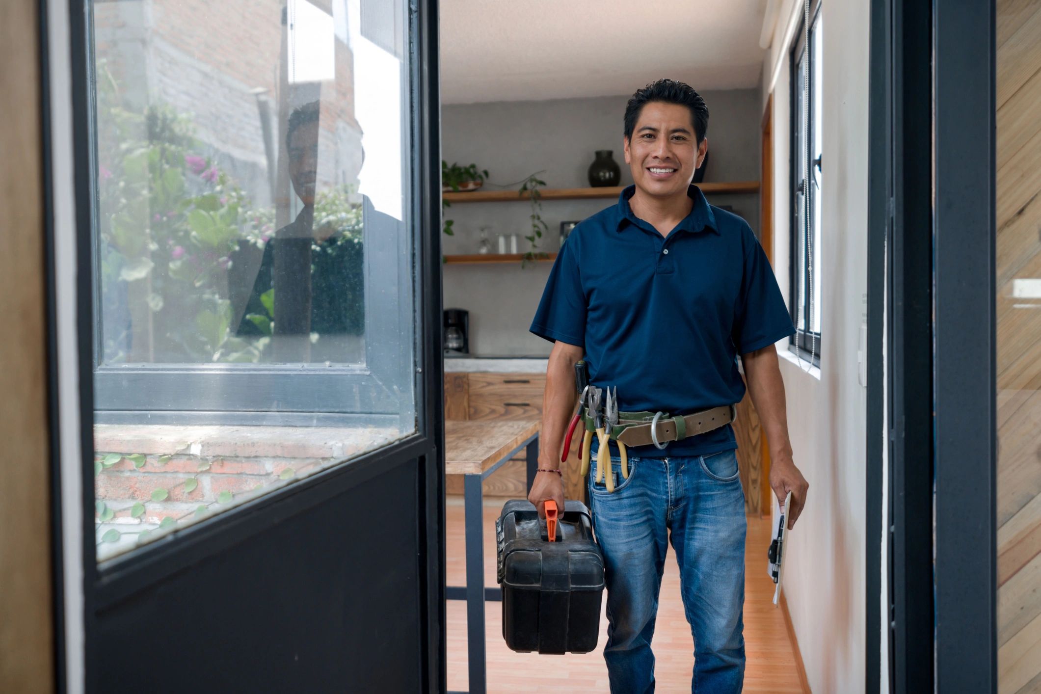 Plumber arriving for a house call with a toolbox