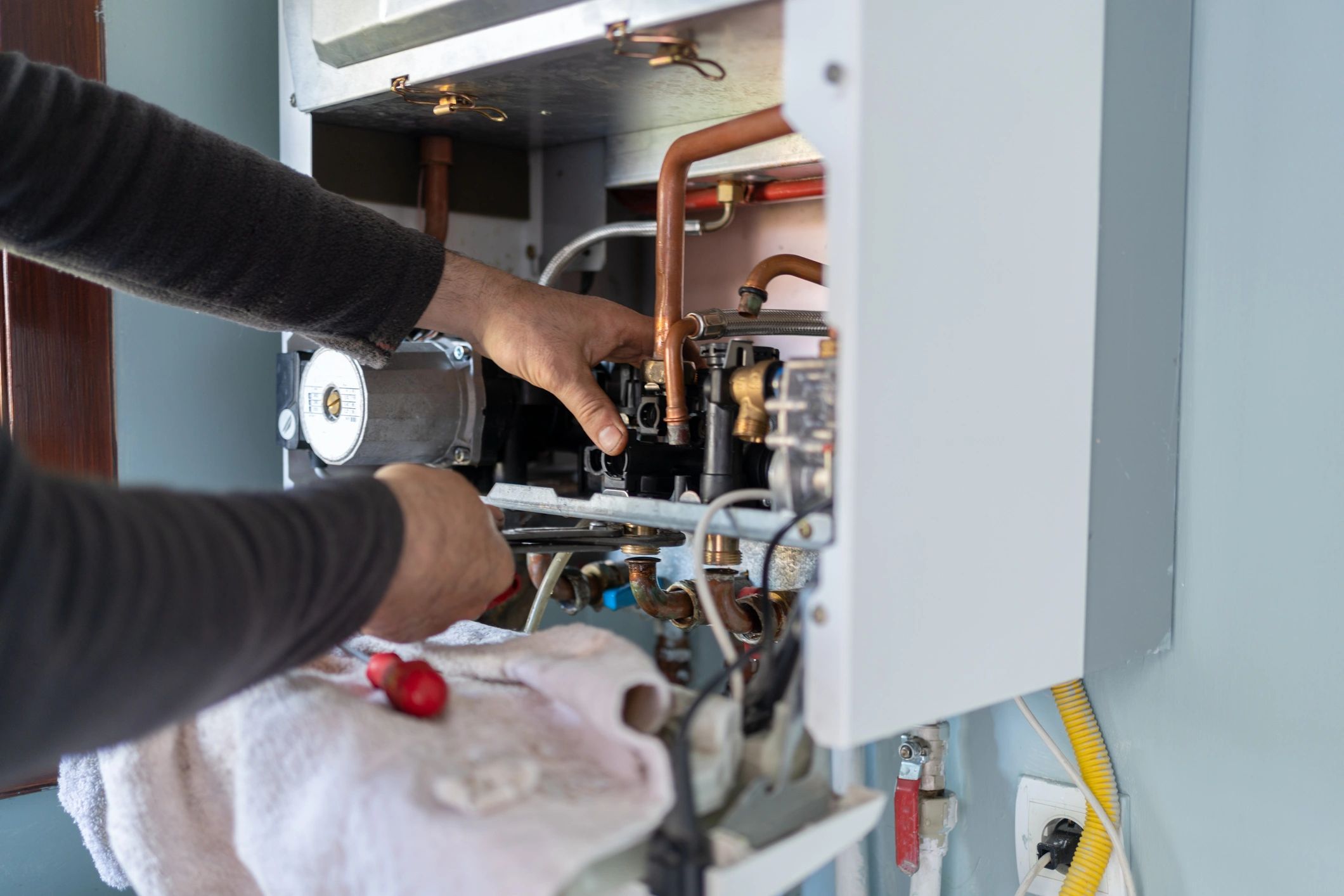 Technician servicing a home hot water system