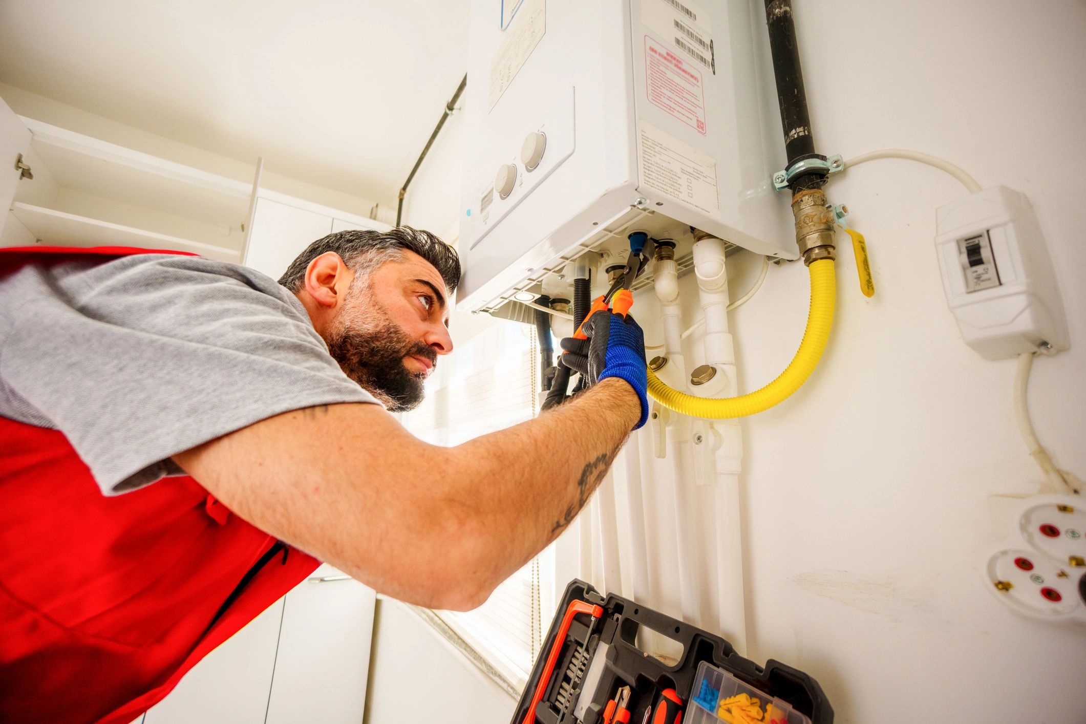 Technician repairing a home gas boiler