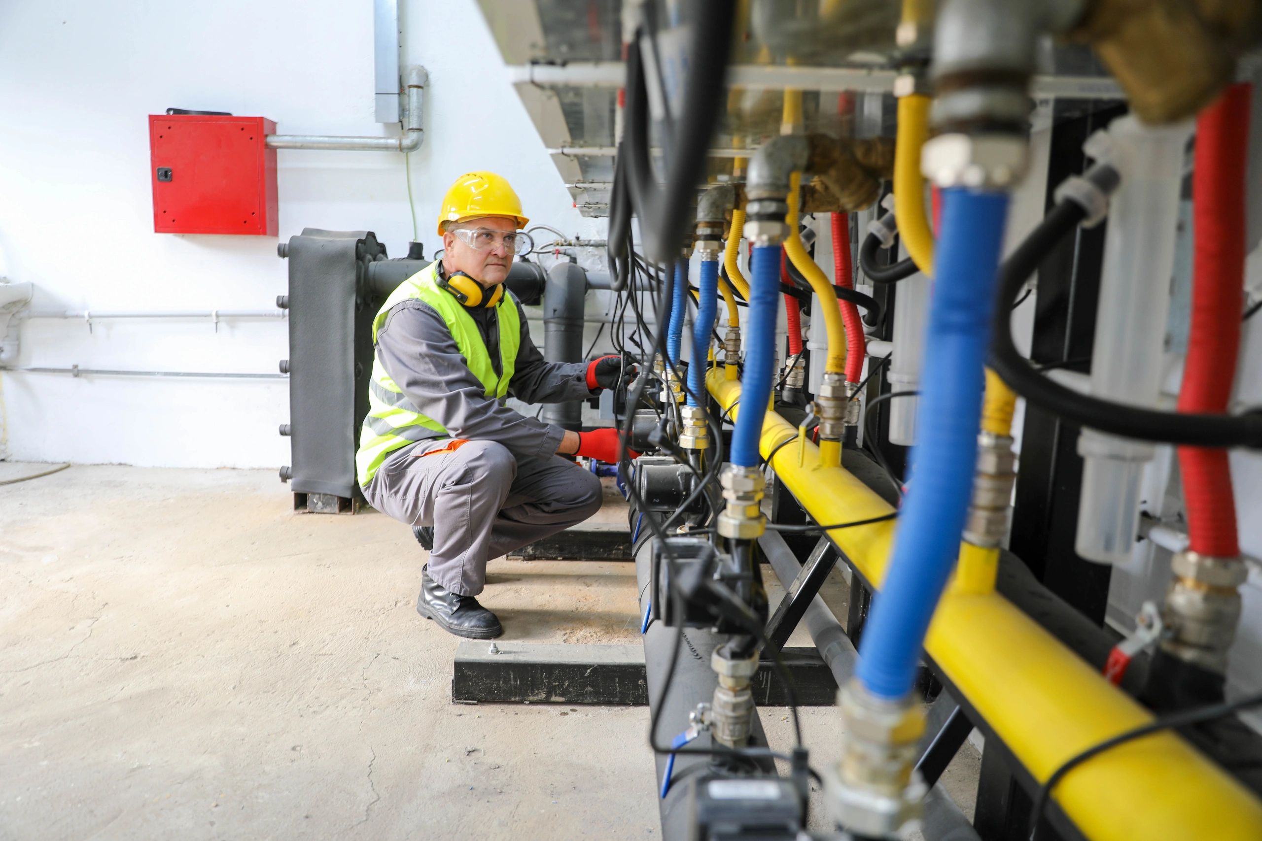 Technician inspecting and repairing gas pipes