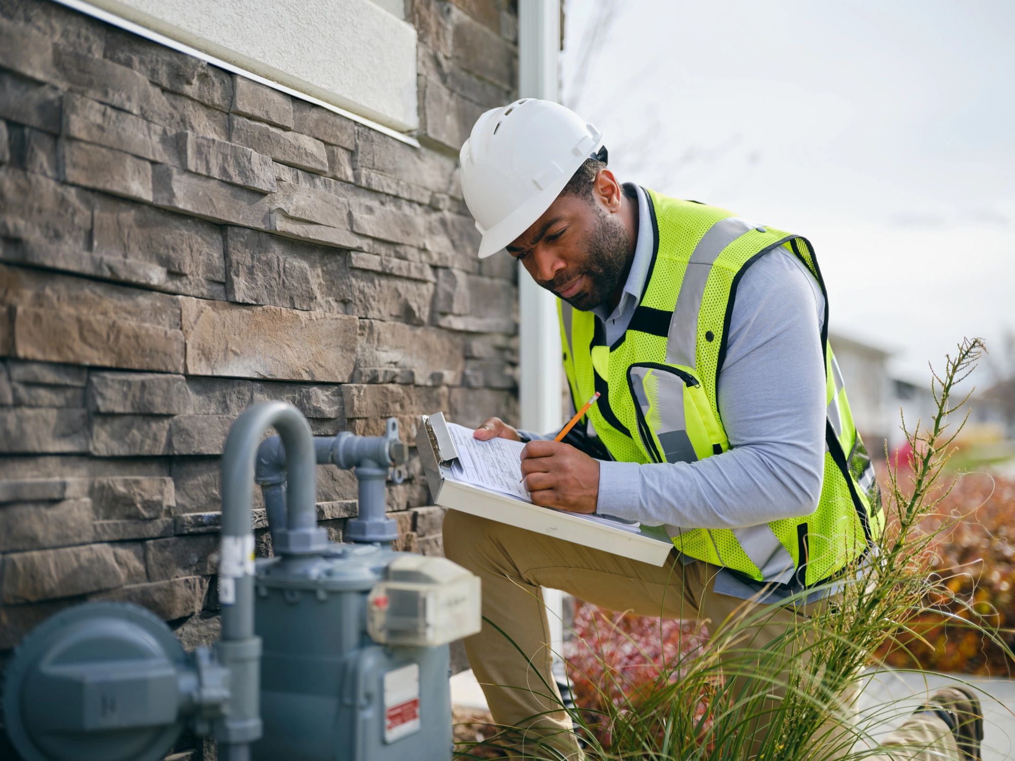 Technician inspecting a residential gas meter